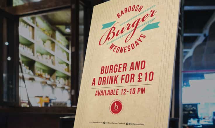 Burger Tuesday Poster with restaurant in background.