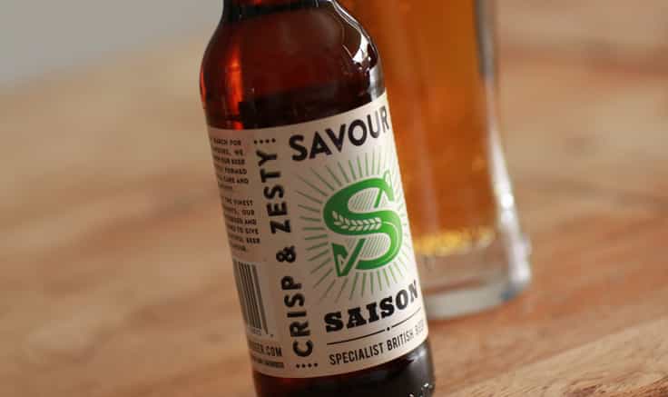 Bottle of Savour Beer on a rustic wooden background.