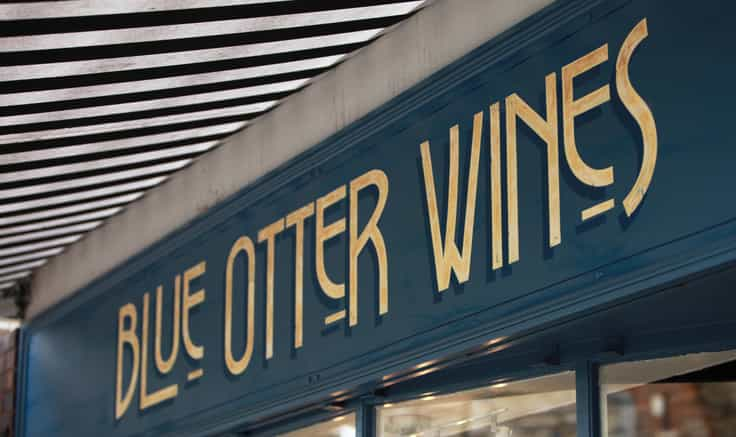 Photograph of Blue Otter signage under awning.