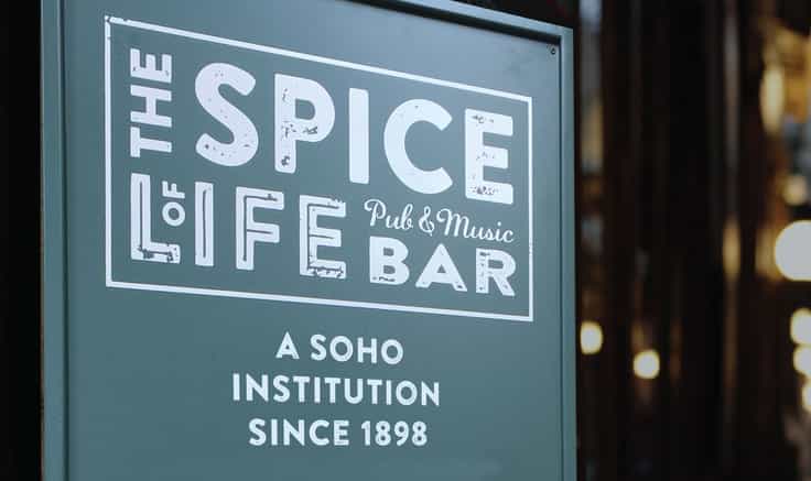Restaurant brands: image of The Spice brand on a sign in a busy London street.