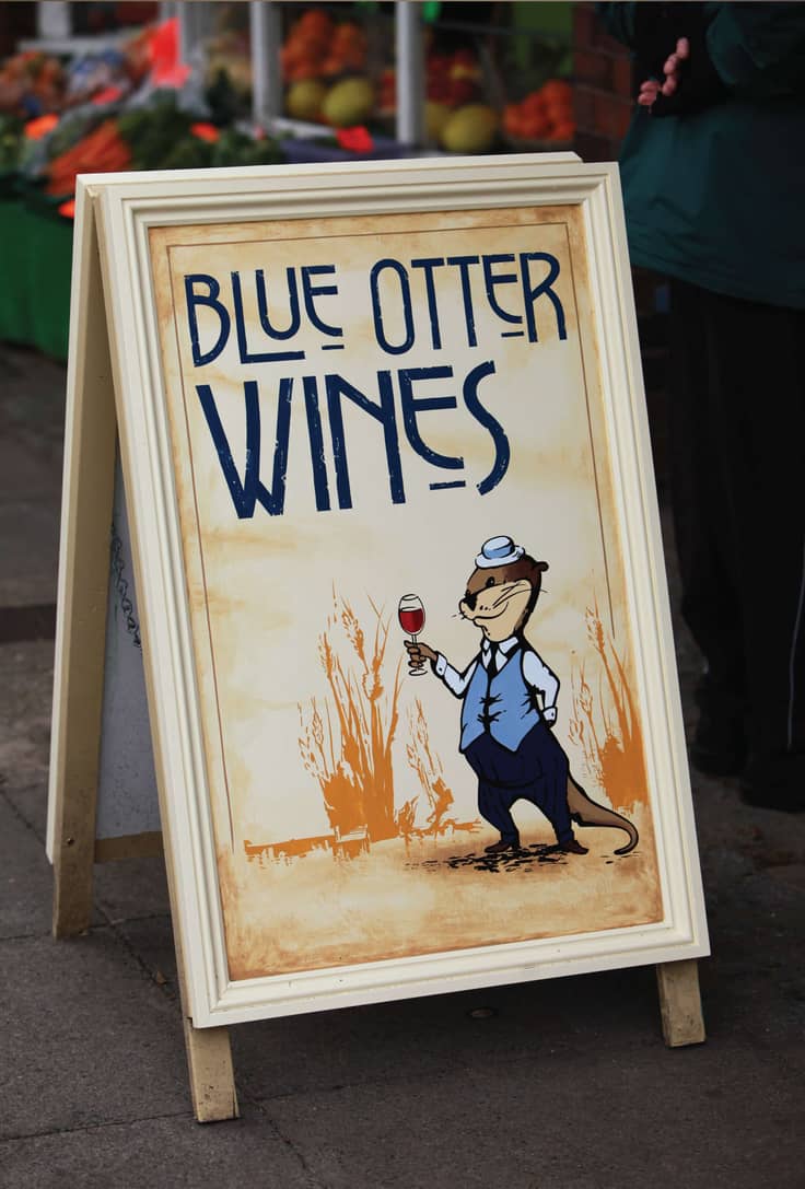 Blue Otter A board outside shop.