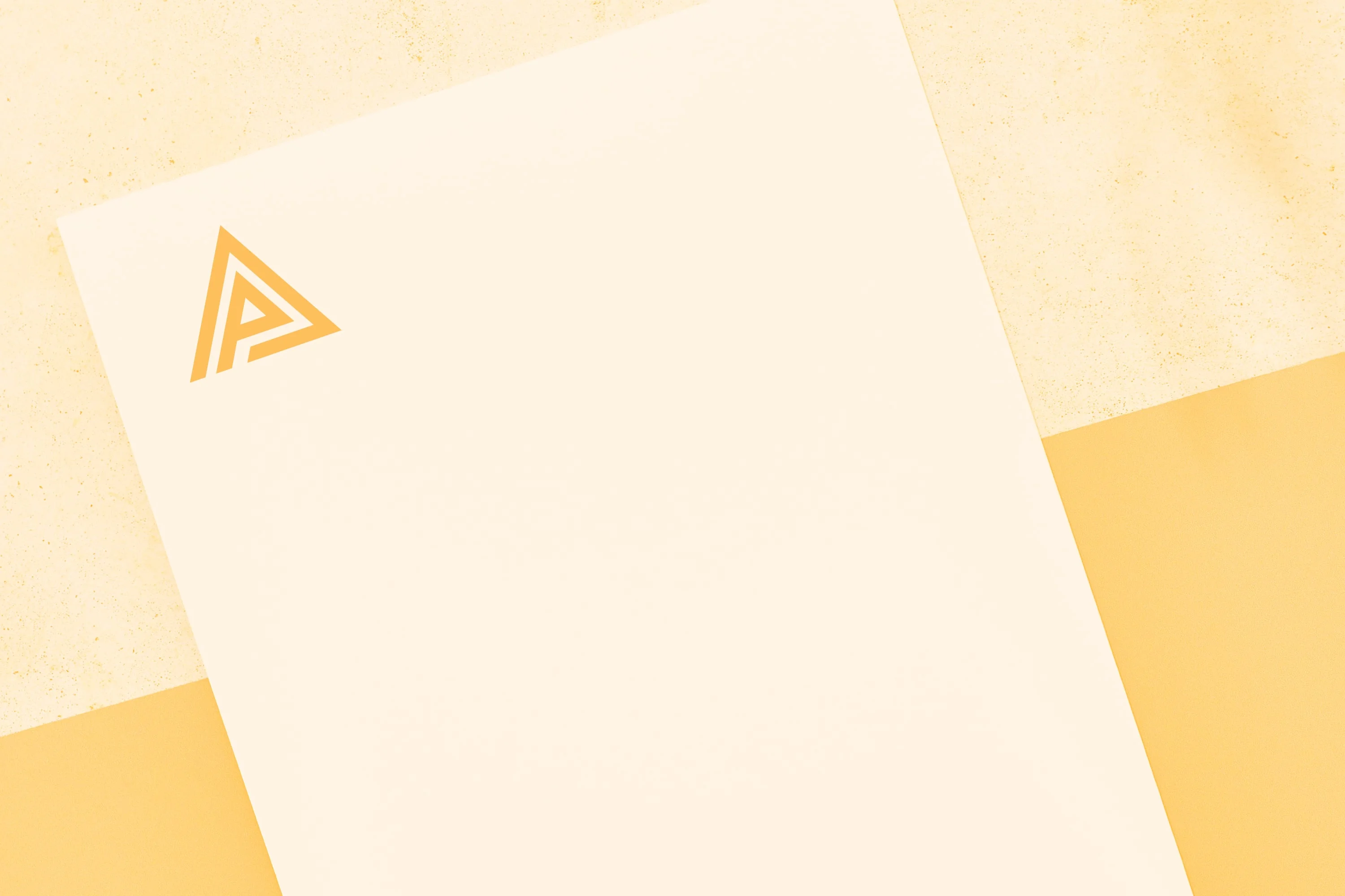 branded letterhead with triangle logo on cream paper amber background