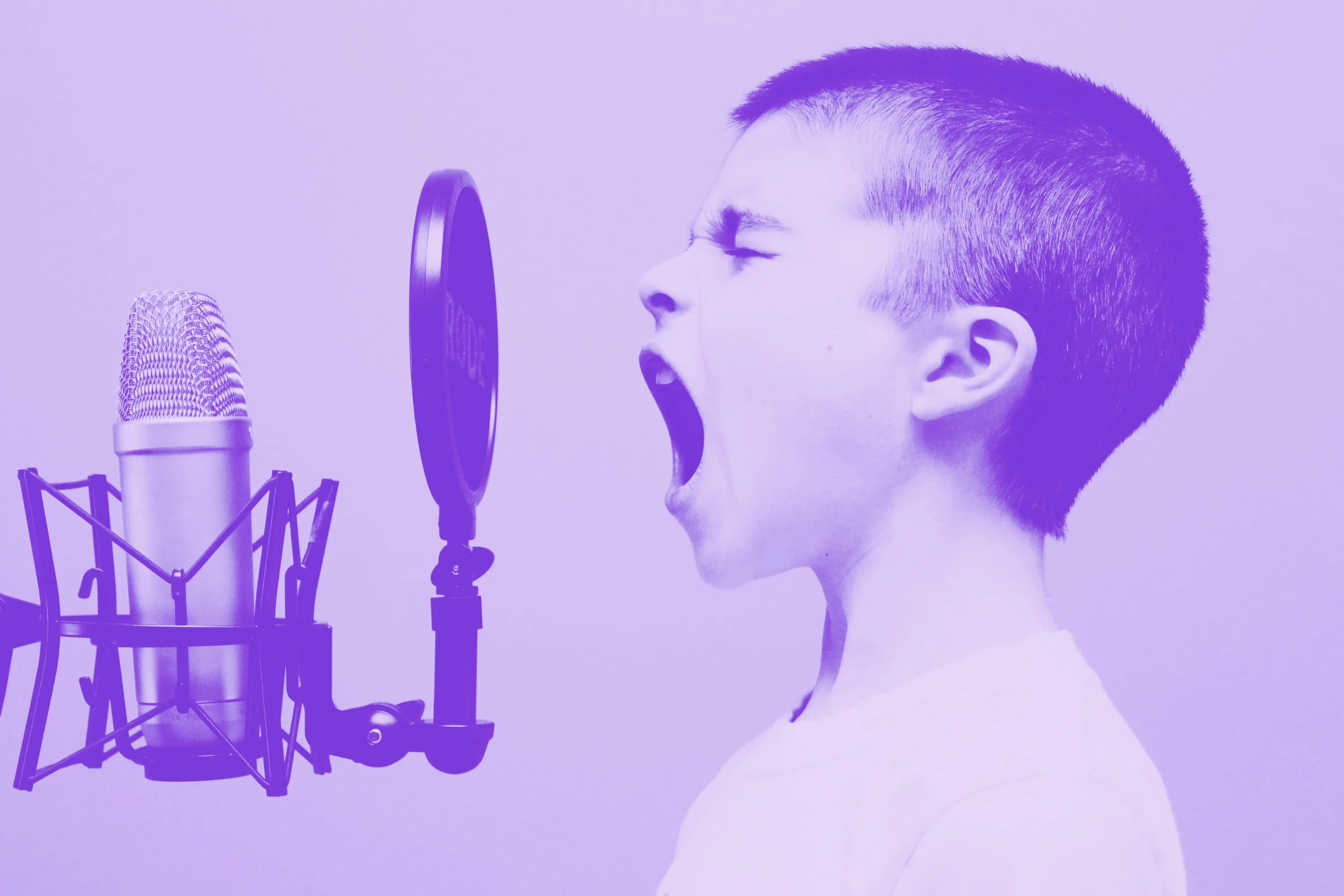 boy shouting into studio condenser microphone with pop filter purple