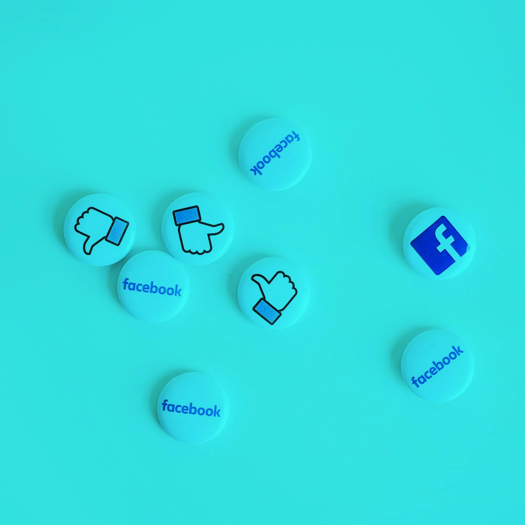 facebook button badges scattered on teal background social media marketing