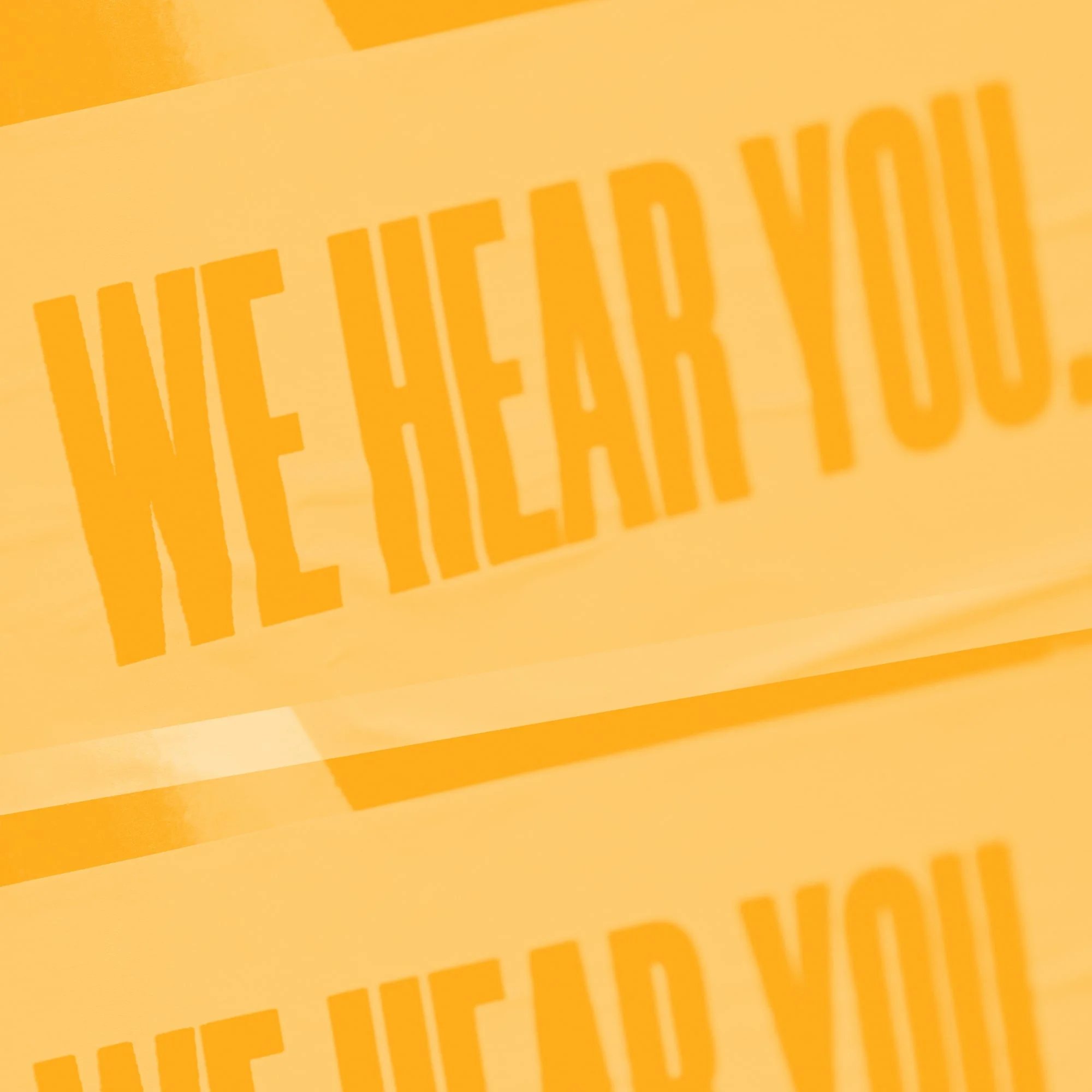 bold orange we hear you text typography on amber background customer support