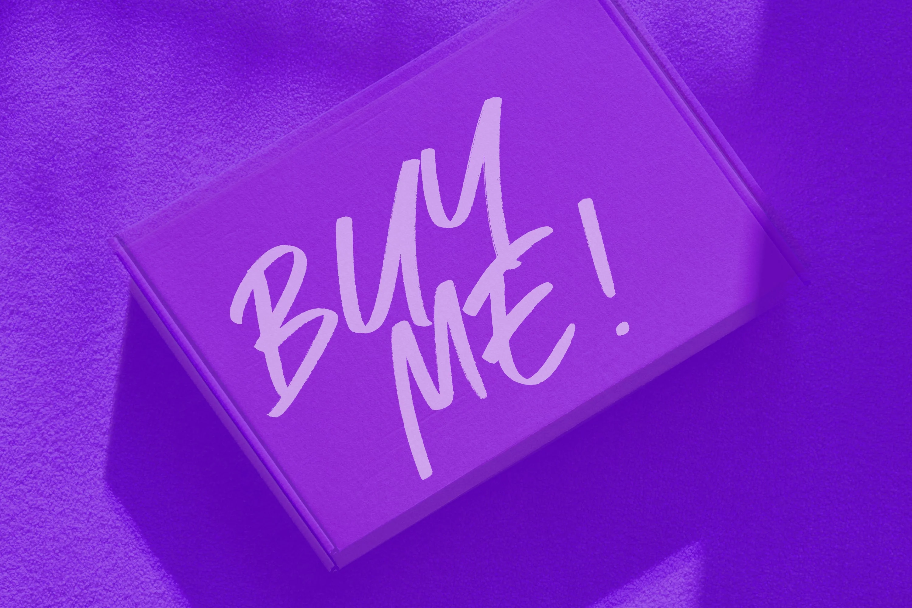 glossy purple gift box with buy me handwritten text purple background