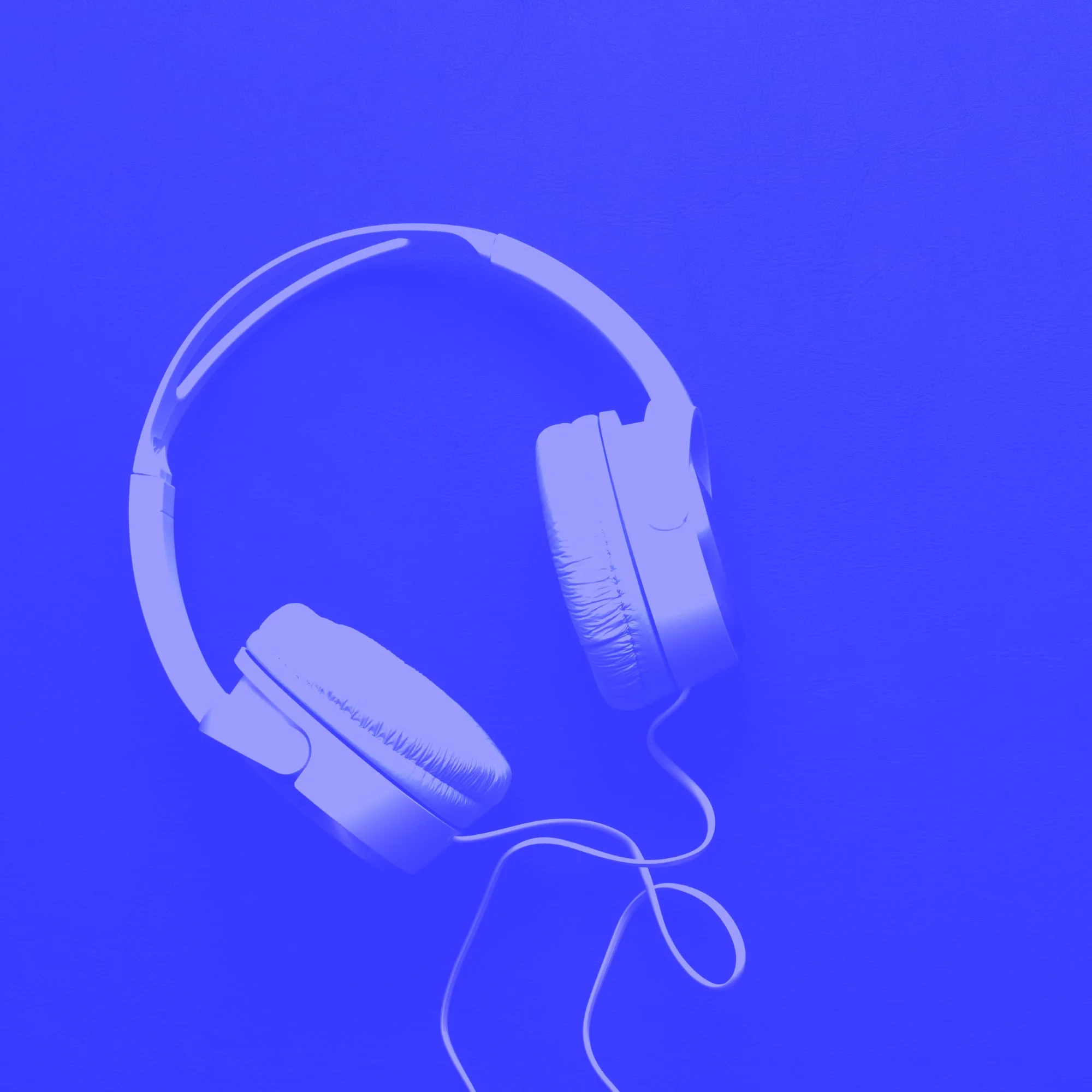 wired over ear headphones floating on bright blue background audio product
