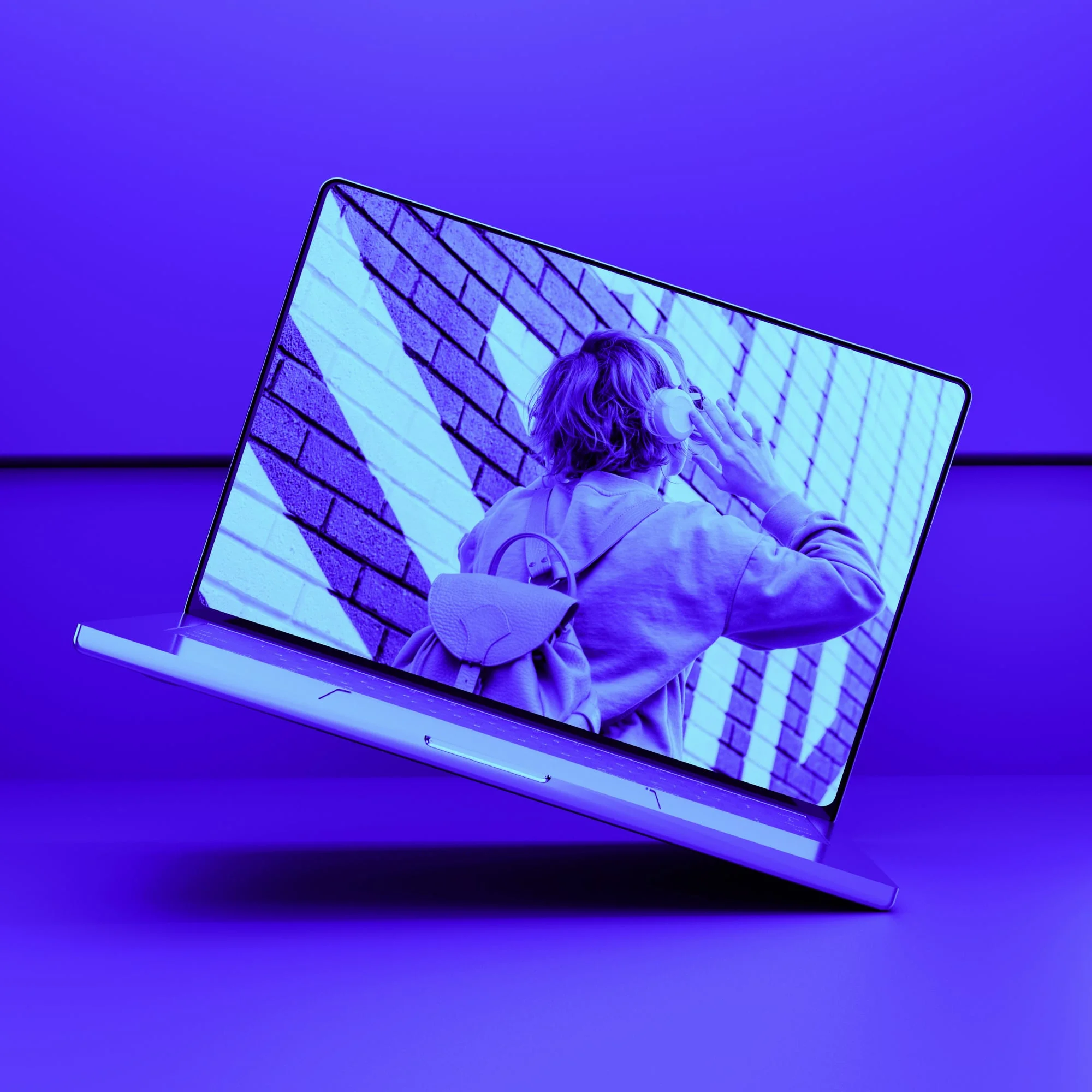 floating macbook laptop showing person with headphones and backpack blue purple toned
