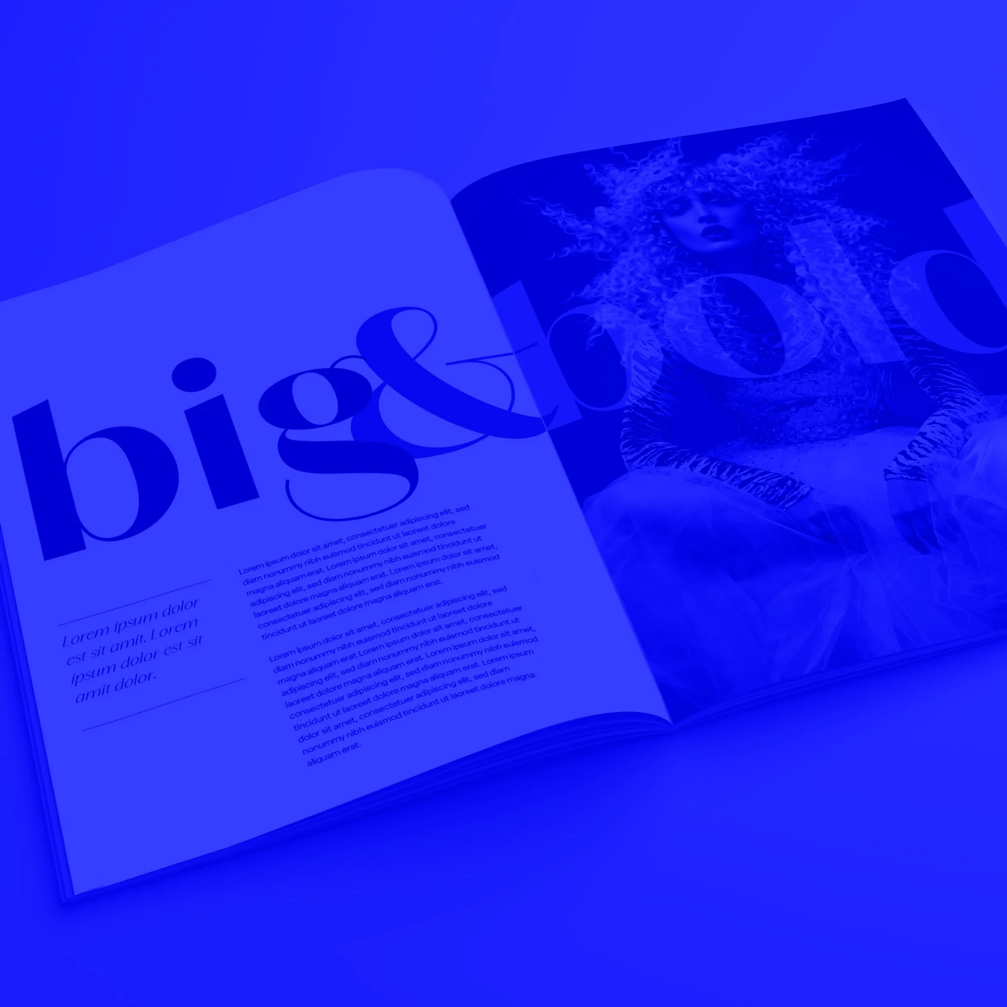 open big and bold fashion magazine editorial spread with model blue toned