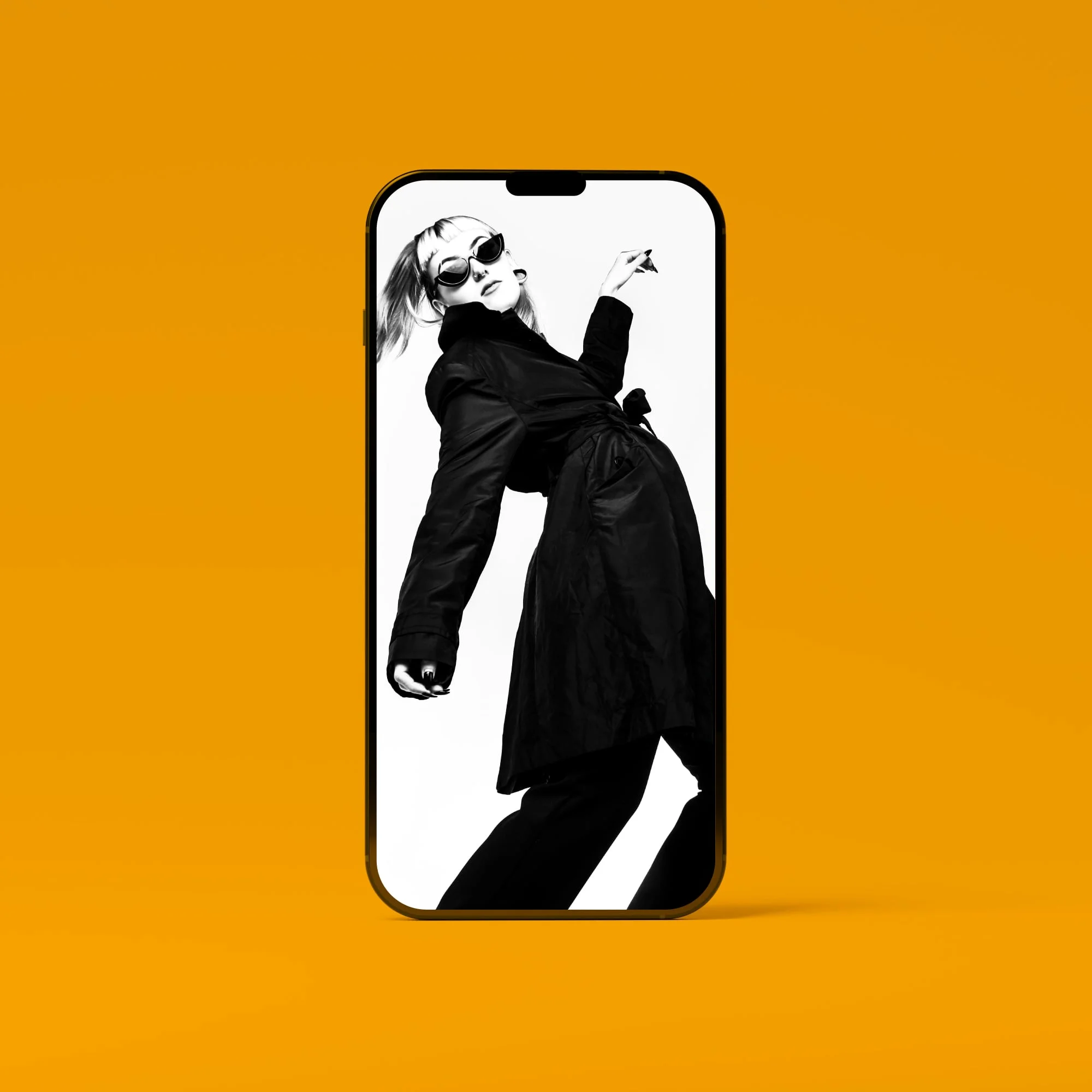 iphone mockup showing black and white fashion model in sunglasses golden amber background