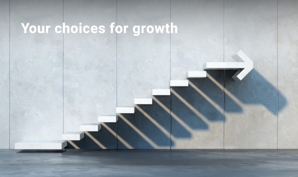 Abstract image of white steps up a grey wall with arrow on last step.