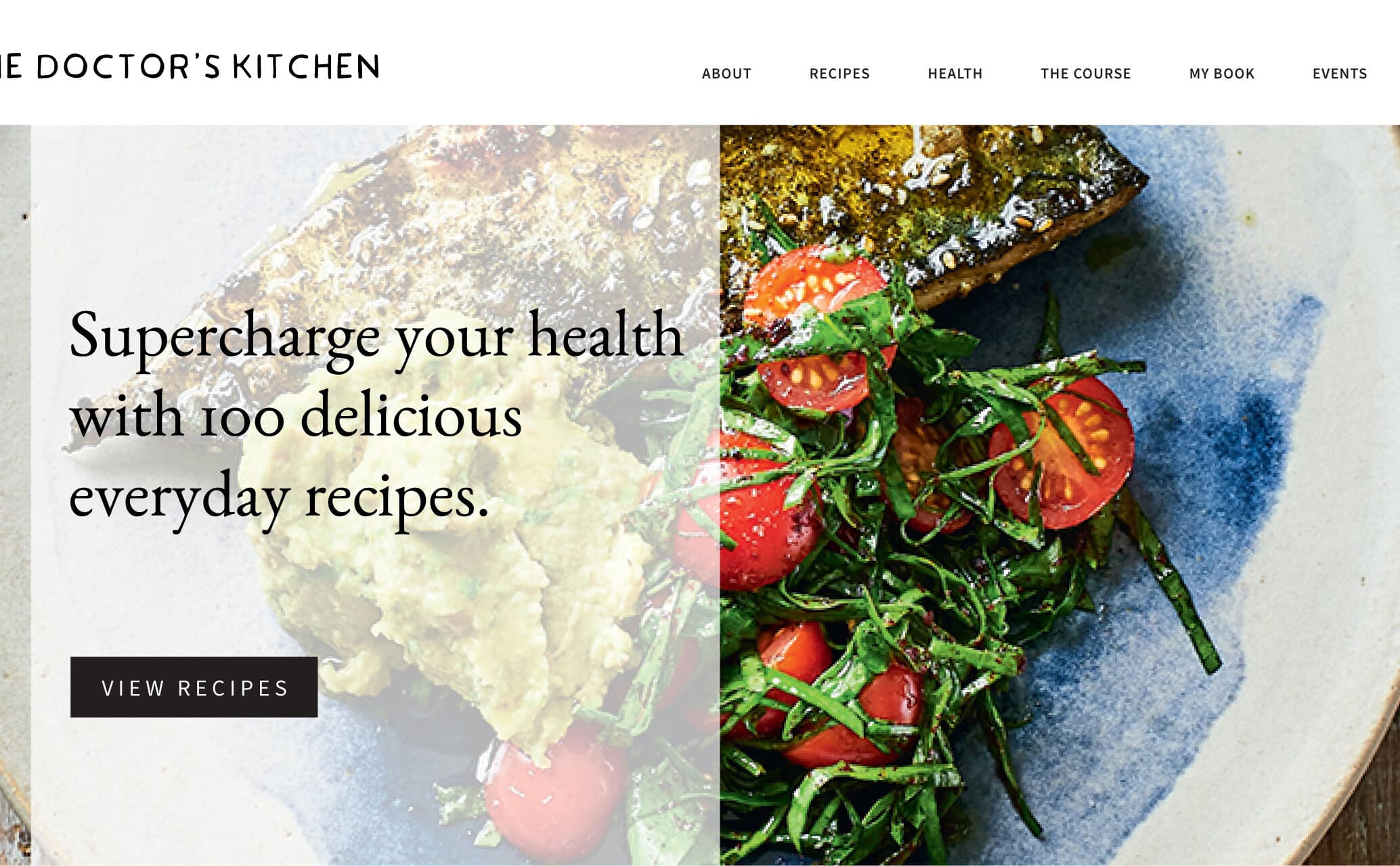 Hero section from The Doctor's Kitchen website with a beautiful overhead shot of grilled fish and vine tomatoes with branding, navigation and the strapline 'Supercharge your health with 100 delicious everyday recipes.