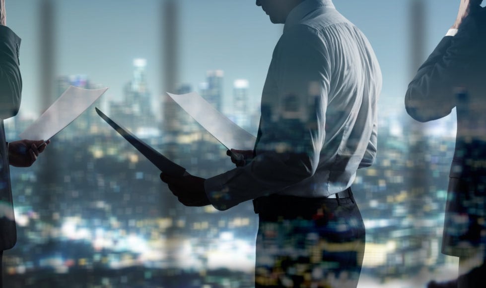 financial-website-branding-images-3a Financial city businessman holding papers superimposed over an abstract dark city scene.