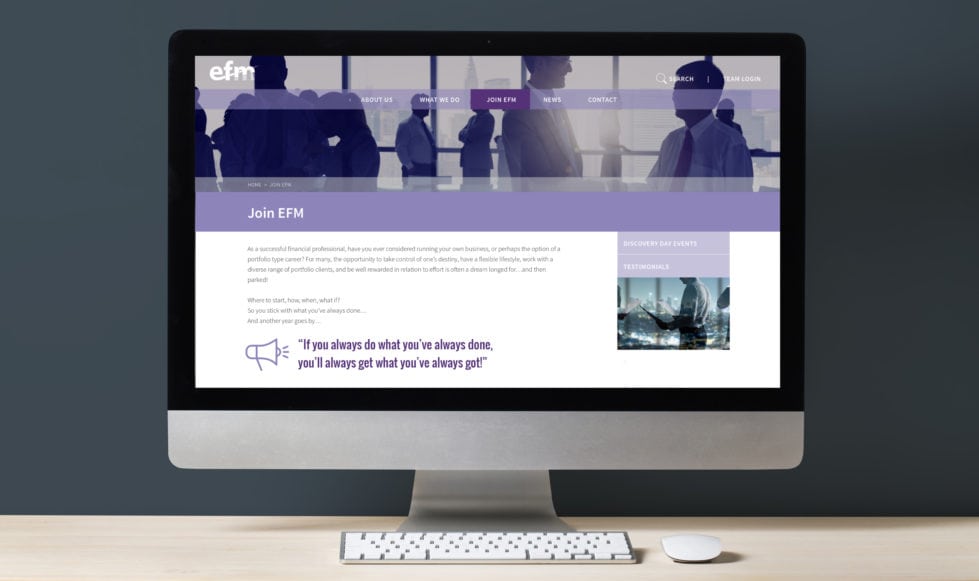 Financial website design development Front-on view of desktop computer screen on a light wooden worktop with a dark grey background. Screen shows the join us page top section of the EFM financial website.