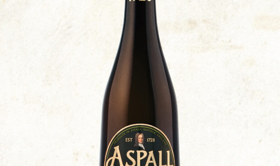 Photograph of a bottle of Aspall Harry Sparrow cyder on a cream textured backdrop.