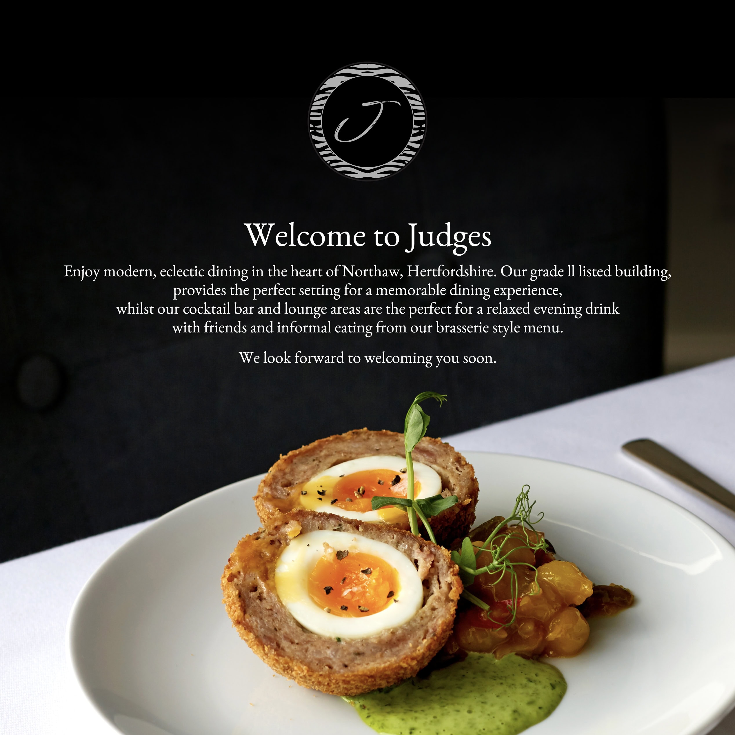 Judges website “Welcome to Judges” section shown over a scotch egg dish on a white plate