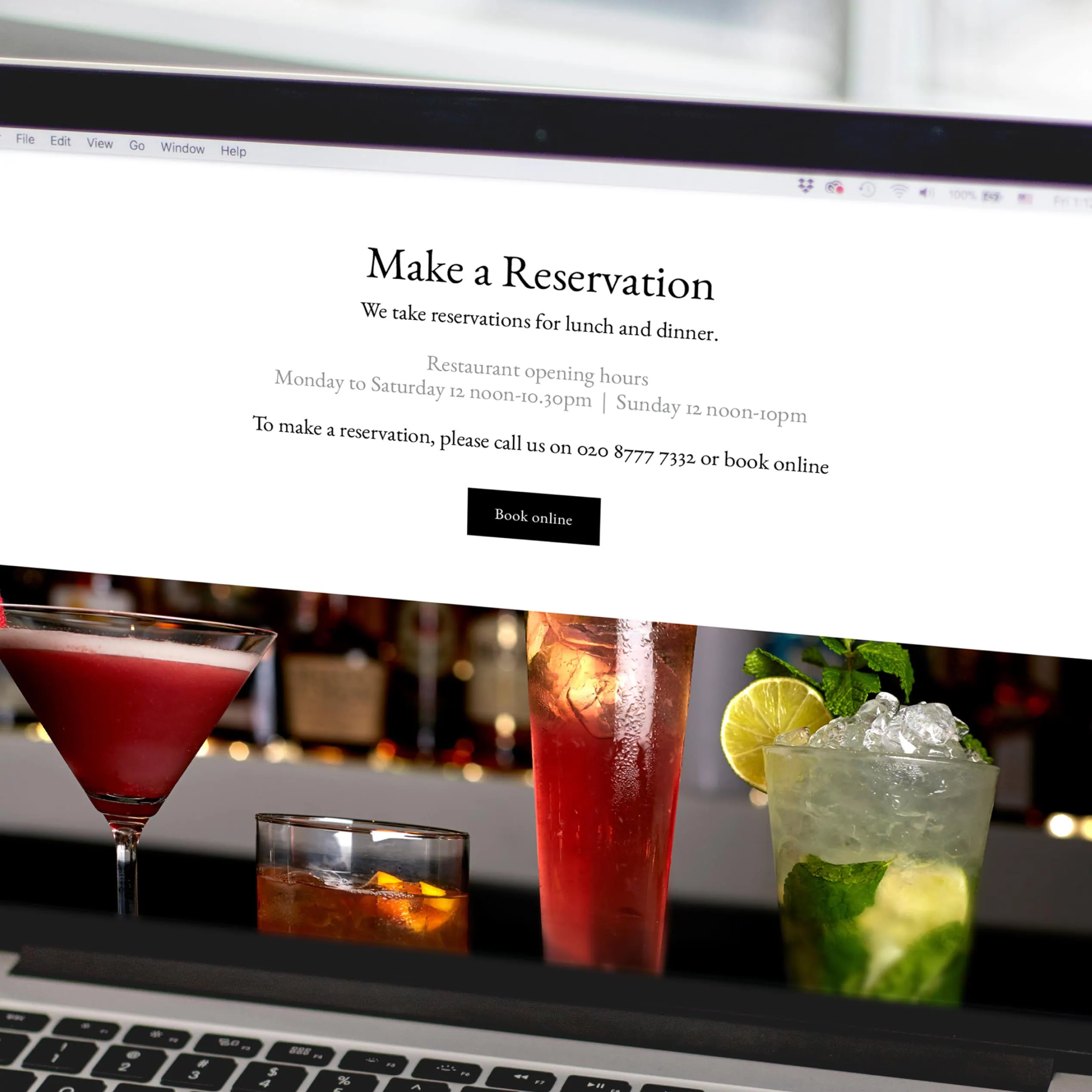 Laptop screen showing Judges “Make a Reservation” page above cocktail photography
