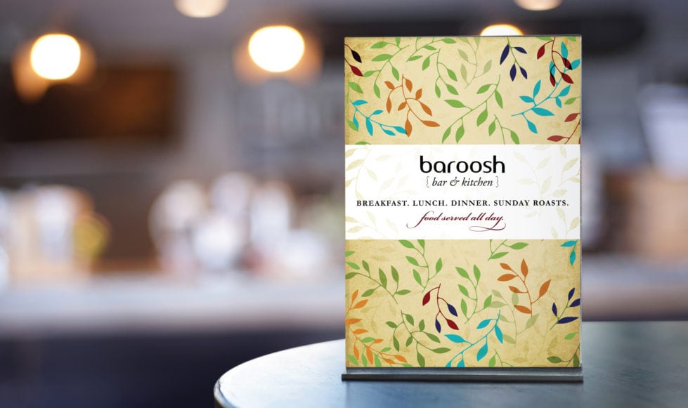 Restaurant menu design Baroosh, Hertfordshire interior shot focusing on a menu on a table.