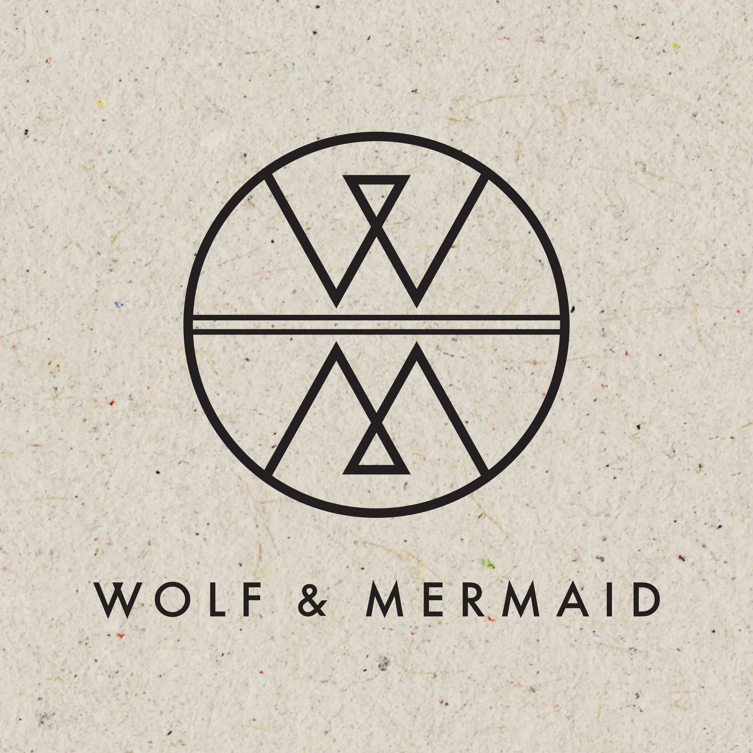 Wolf & Mermaid circular logo and wordmark printed on speckled recycled paper