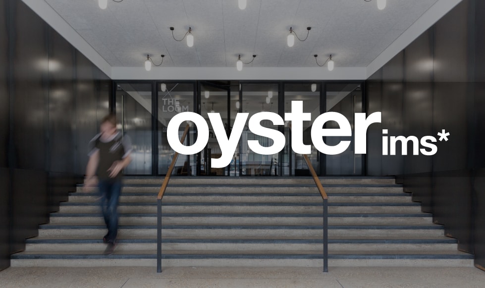Oyster IMS logo reversed out white from a darkened photograph of their outside entrance.