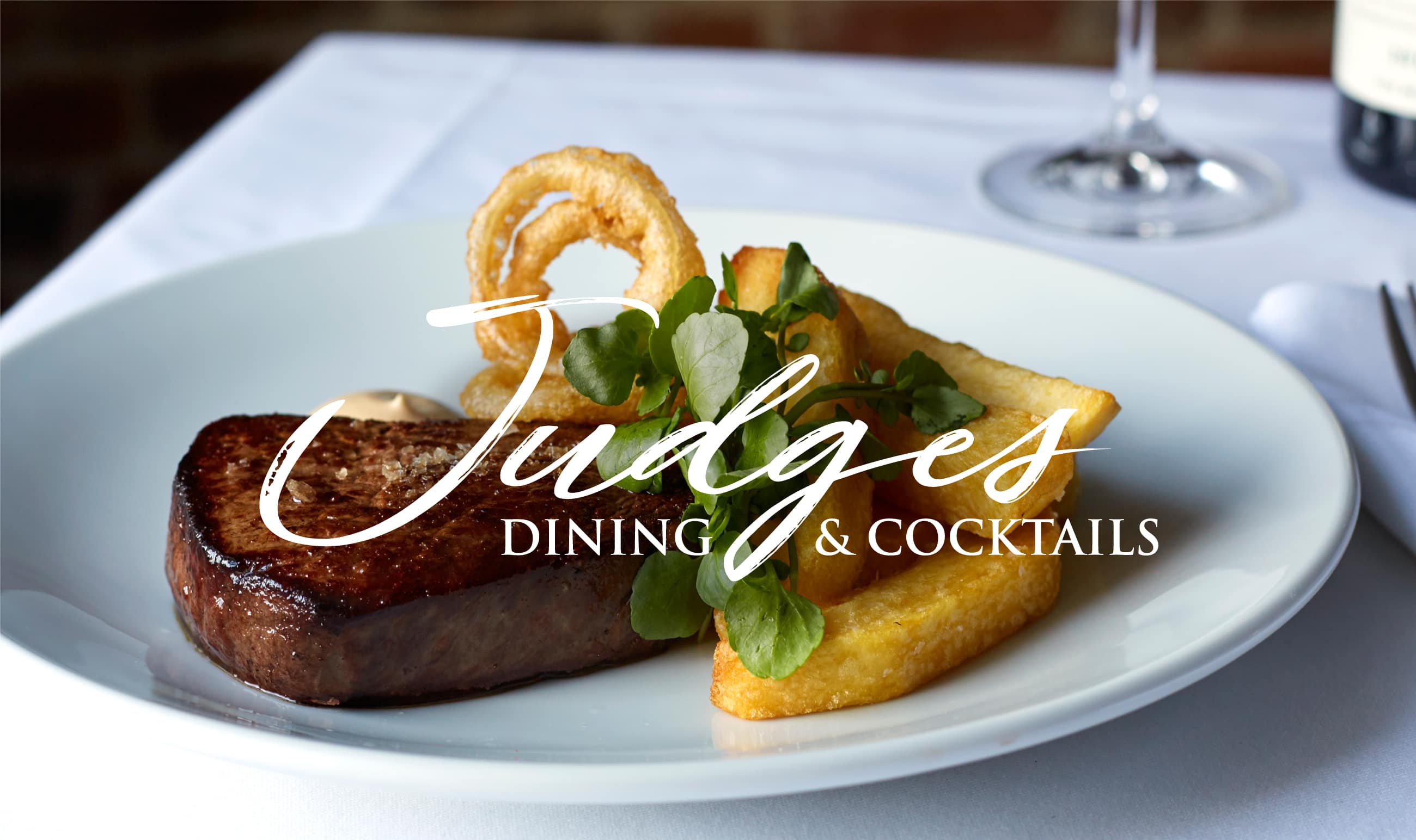 Judges homepage with a close up photo of steak and chips with the Judges logo reversed out white.