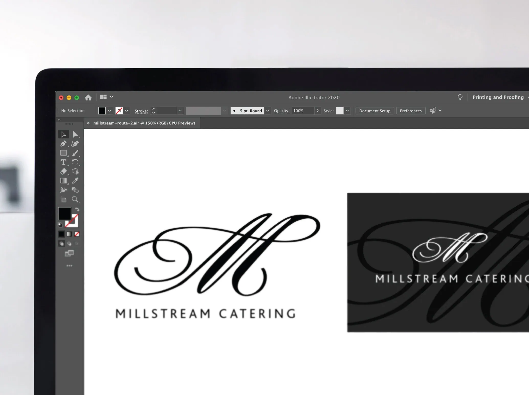 Millstream catering logo and business card designs depicted on a computer screen. A large script 'M' forms the main logo.