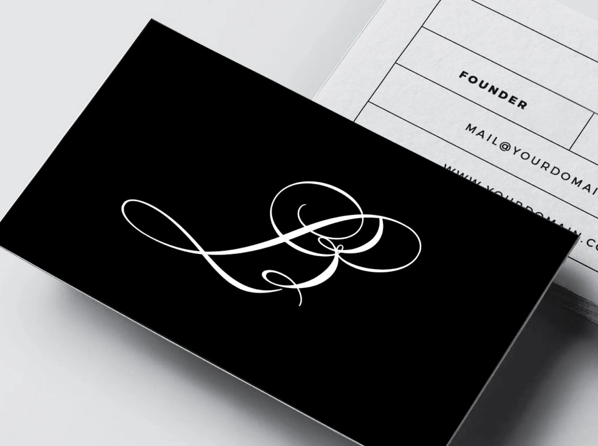 L Beauty business card, black card with white LB monogram in a script font.