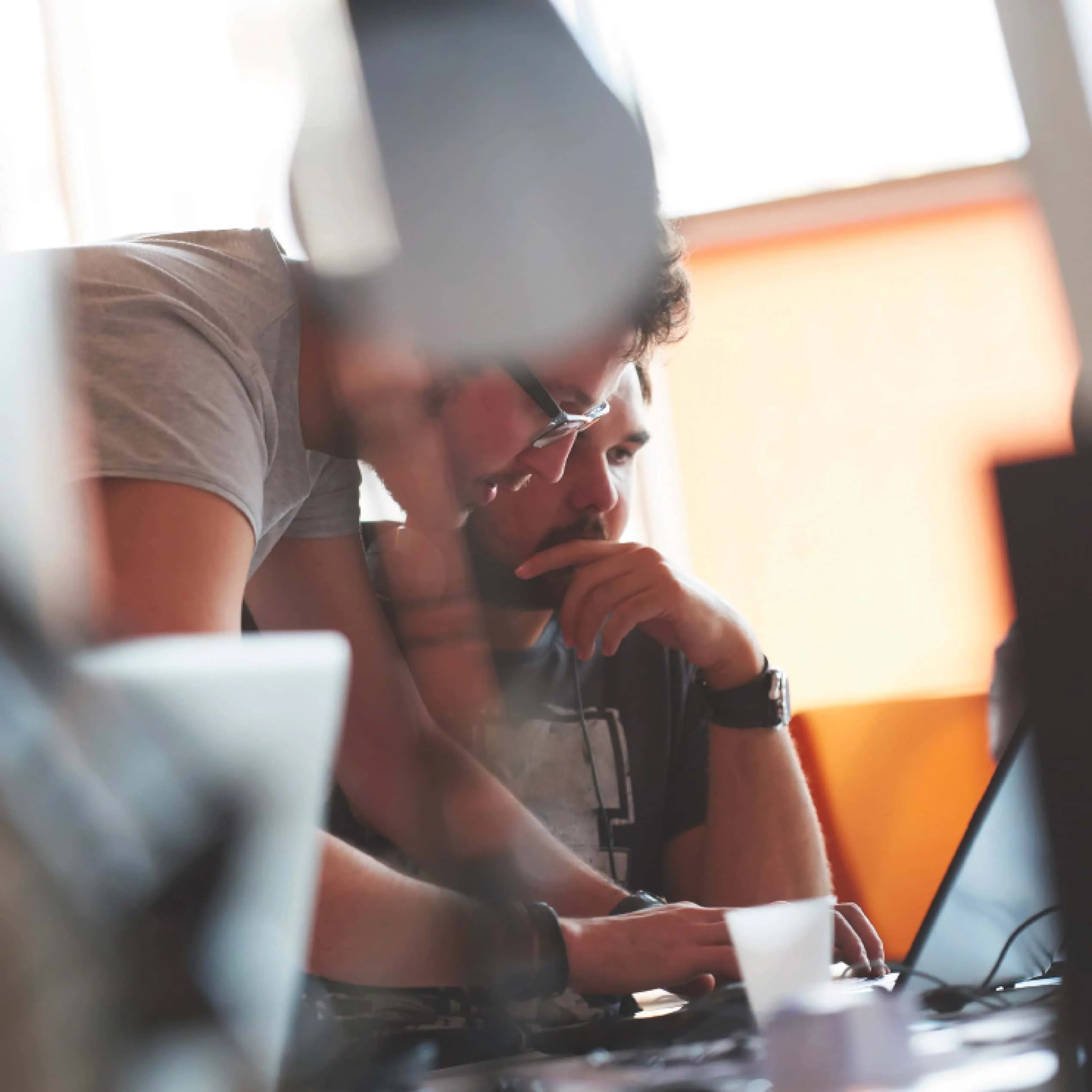 Two colleagues collaborating at a laptop during a working session