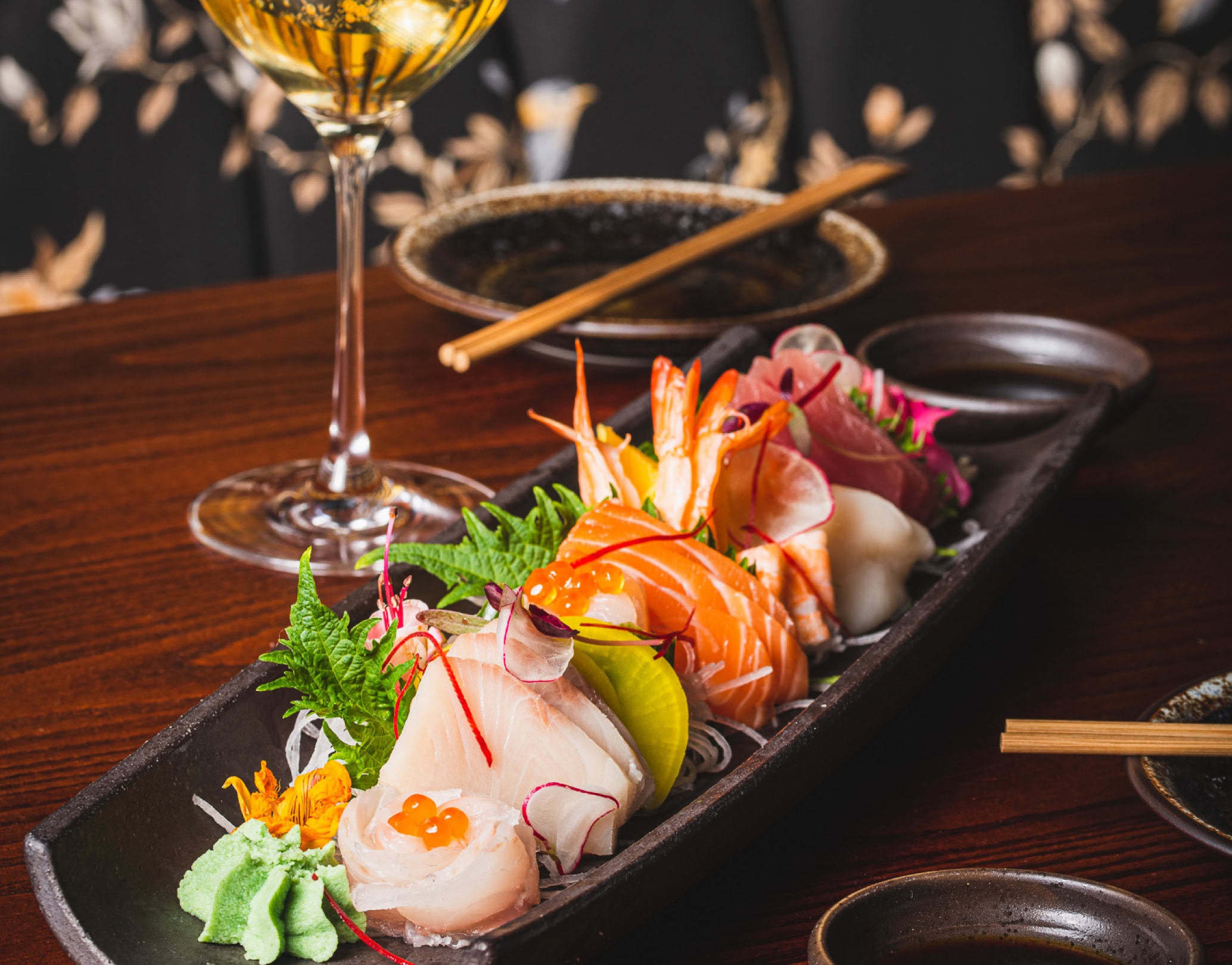 Sashimi platter with cocktail on table