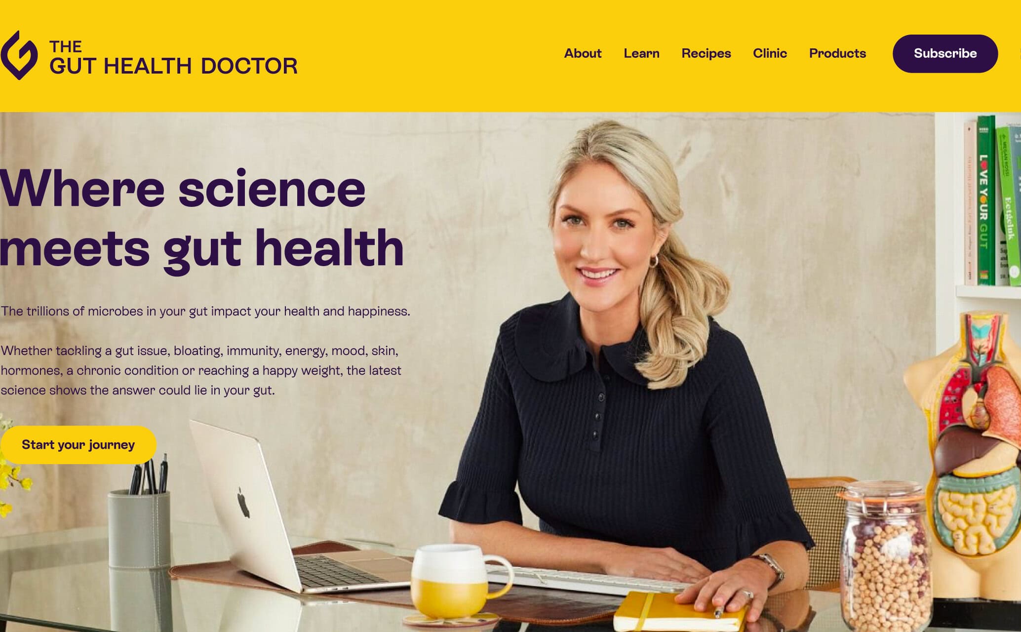Homepage hero showing Dr Megan Rossi at a desk, with gut model and books on a shelf