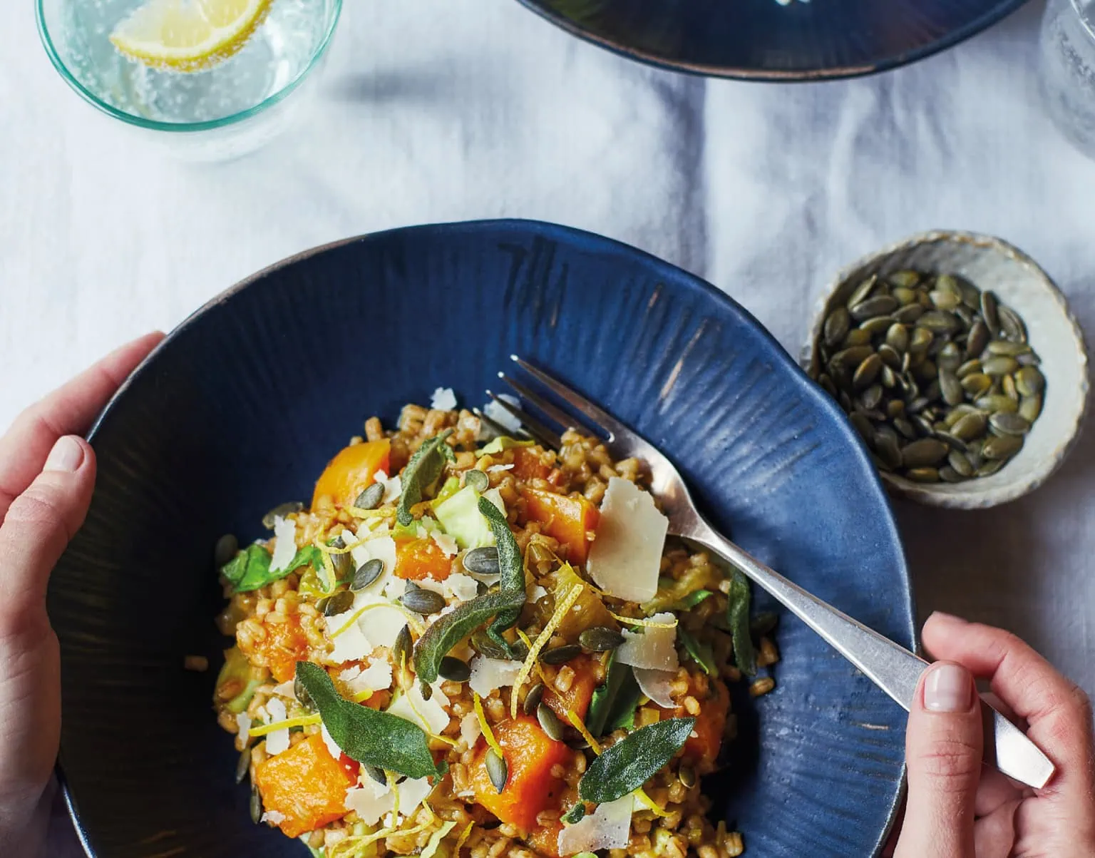 Overhead photo of a grain bowl with herbs and seeds, with The Gut Health Doctor logo overlay at centre