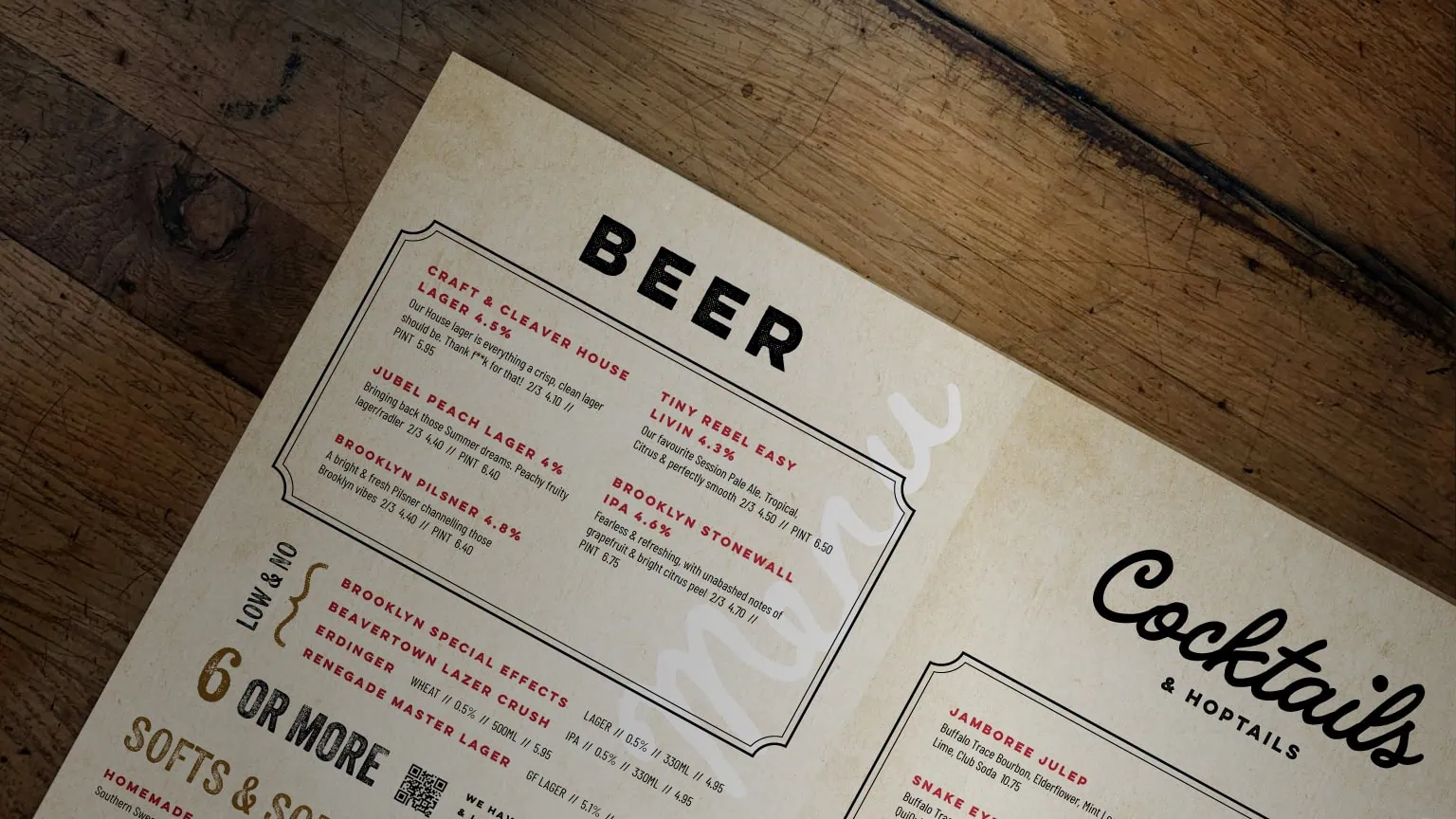 Craft & Cleaver beer and cocktails menu on a rustic wooden tabletop