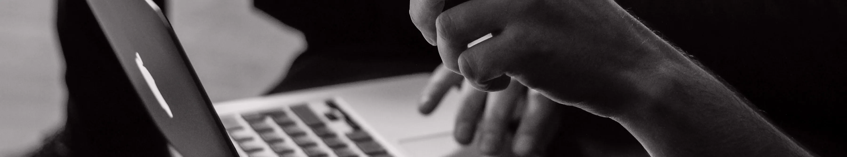 Close up of person using the track mat on a laptop computer.